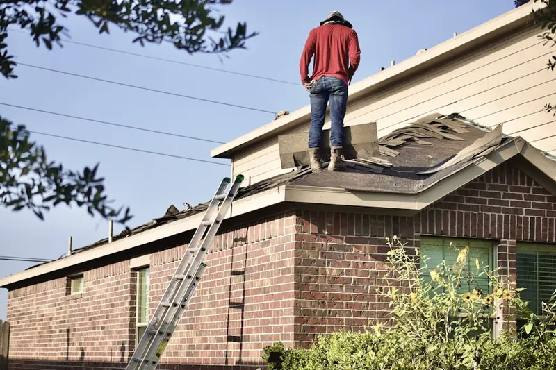 Professional roofer working on a residential roof in Loveland